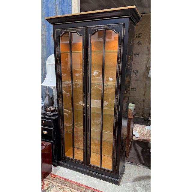 Attributed - Drexel Heritage. Illuminated chinoiserie decorated black lacquered display or collectors cabinet. This piece...