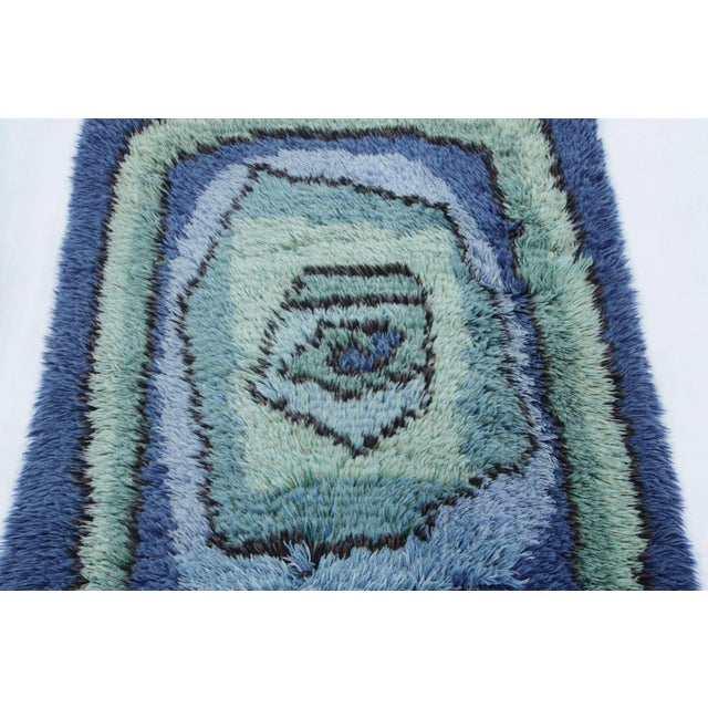 Hand-knotted in lush, high-pile wool in Sweden circa 1960-1970, this 3x4 vintage Swedish Rya rug is a bold new addition to...