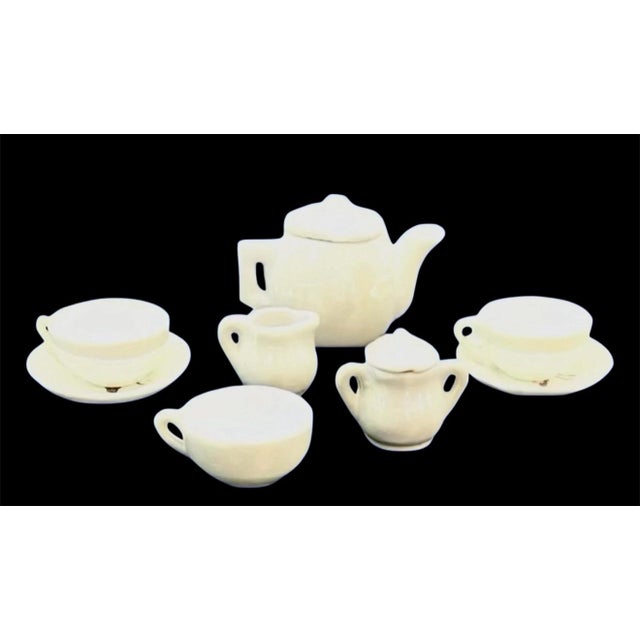 Add a charming touch of vintage whimsy to your collection with this antique Japanese children's miniature porcelain tea...