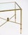 Side table from the Art Deco period in France. This table is made of solid brass with four tapered legs. The four legs are...