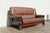 Striking vintage 1970s leather sofa featuring a bold sculptural wood frame and beautifully textured brown leather...