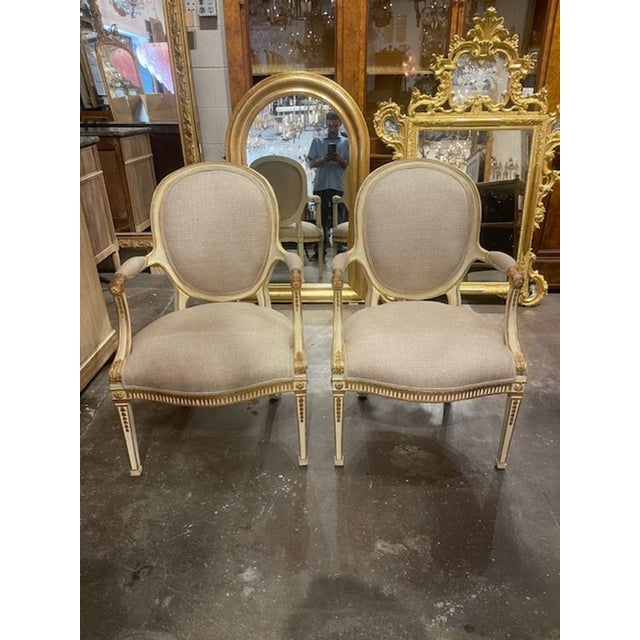This product is a pair of English George III parcel gilt armchairs. These armchairs are classic and elegant pieces of...