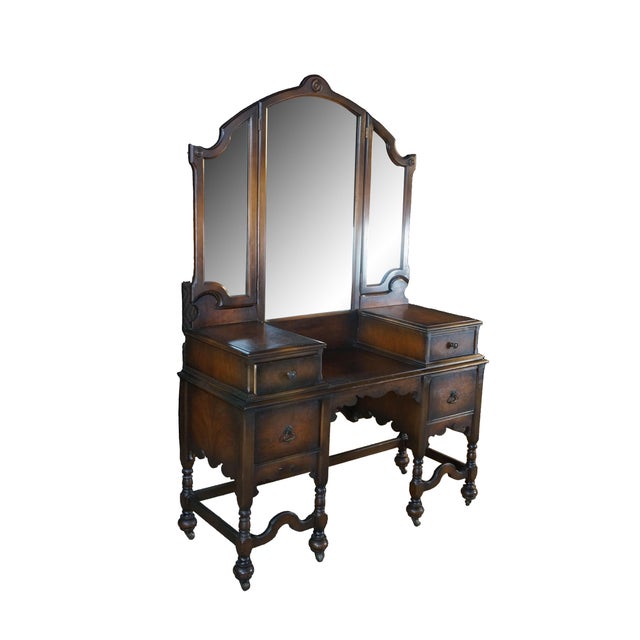 An antique Depression-era makeup vanity crafted in the Jacobean Gothic Revival style, circa 1920s to 1930s. The exterior...