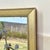 A stunning and rare reverse-painted mirror depicting an idyllic chinoiserie landscape scene with meticulous hand-painted...