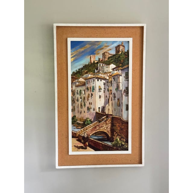 Vintage oil on board depicting a Spanish hillside village with whitewashed houses, terracotta roofs, stone bridge and...