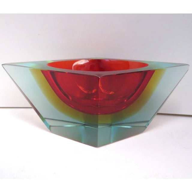 Mid-century Mandruzzato Murano sommerso angled blown glass bowl in ruby red, amber and pale blue. There is a small...