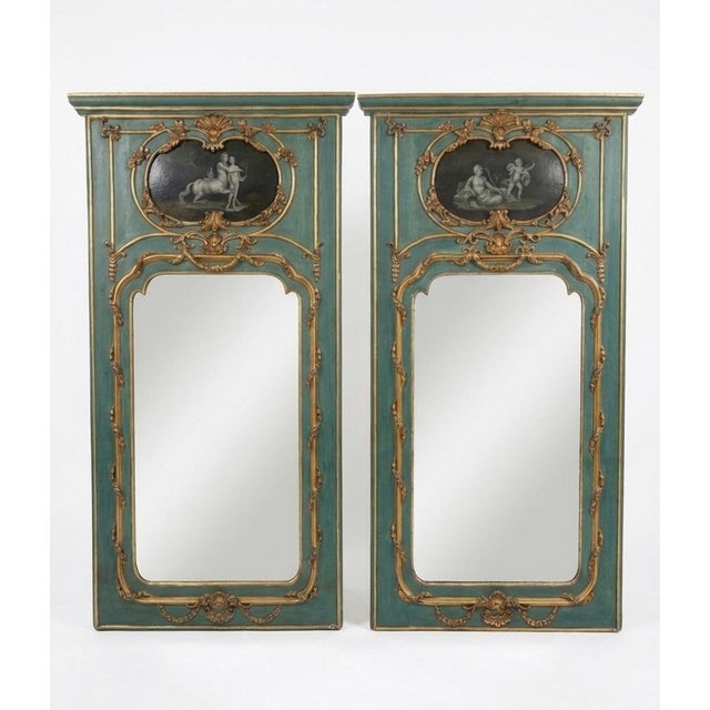 This striking pair of French-style Neoclassical trumeau mirrors features an elegant, weathered verdigris or sage green...