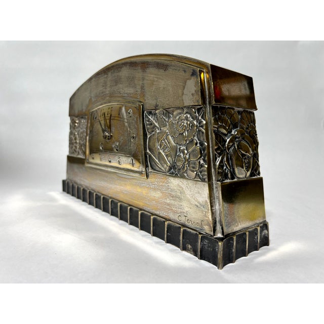 A French Art Deco silvered bronze mantel clock by C. Terras, dated 1925. The case is beautifully cast with a domed top, a...