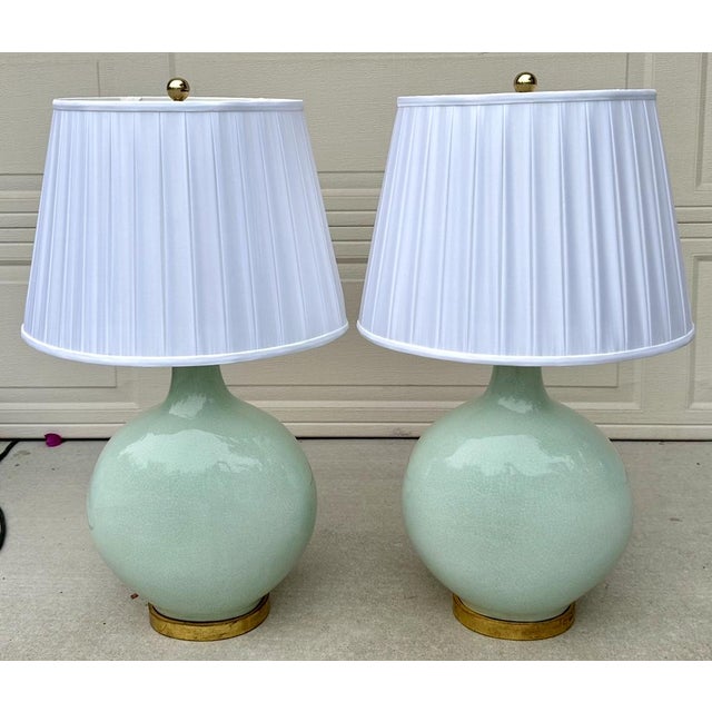 A stunning and elegant pair of large vintage celadon porcelain table lamps, likely dating to the mid-20th century. These...