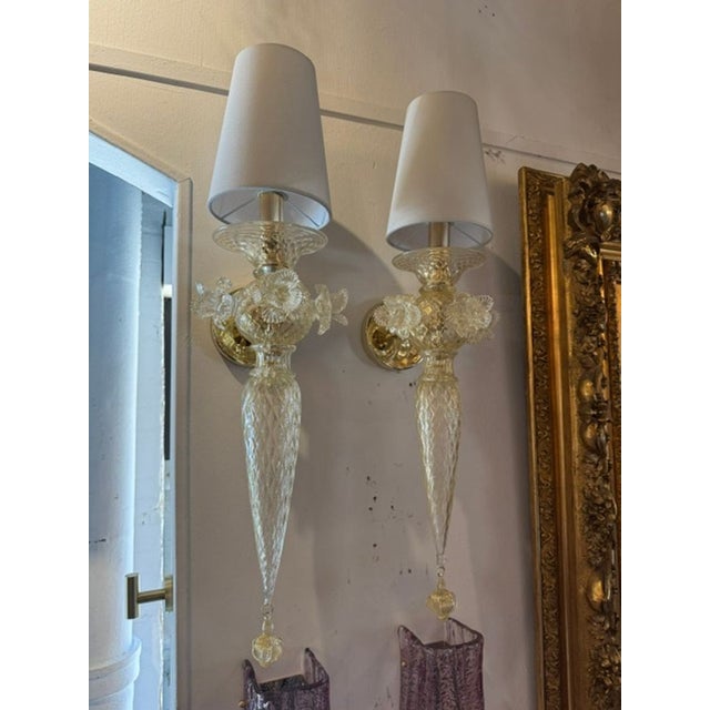 The Murano Gold Venetian Style Flower Sconces are decorative wall fixtures that add a touch of elegance and luxury to any...