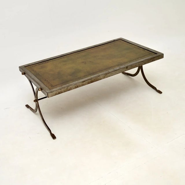 A smart and unusual vintage French steel and leather coffee table, dating from the 1960’s. This has a great design, the...