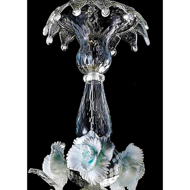 Venetian floreal Murano glass chandelier with leaves and flowers pinched by hand full of precious white details. That give...