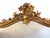 Elegant French Louis XV style giltwood mirror featuring an ornate Rococo-inspired frame with richly carved floral and...