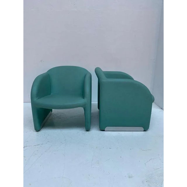 Clean and slim-lined 1980s club chairs, upholstered in turquoise vinyl. Very similiar to the "Ben chair" by Pierre Paulin,...