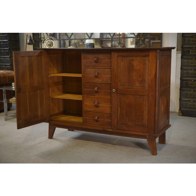 A typical oak sideboard from the Reconstruction period, with a restrained yet highly structured aesthetic. Its balanced...