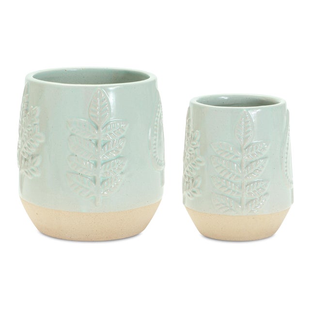 Showcase your greenery with elegance using this Set of Two-Tone Porcelain Planters. Designed with a delicate leaf motif...