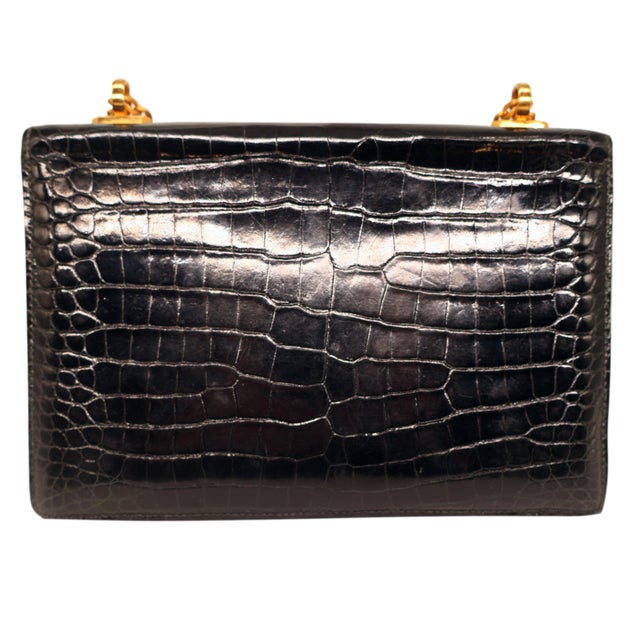 Hermès Black Porosus Crocodile Alcazar Top Handle Shoulder Bag, 1980. This collector’s piece is truly an exceptional...