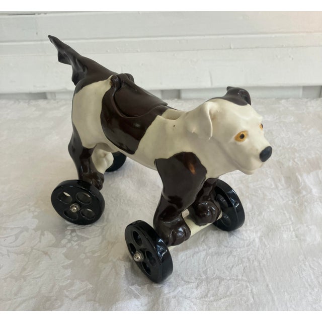 Charming British ceramic black and white dog on wheels. The saddle lifts exposing a trinket space. Very cute and unique...