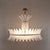 An elegant italian art deco chandelier, composed of individually handcrafted white murano glass feather-shaped elements...