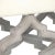 Bench with ornate cross legs with distressed grey legs and upholstered in off-white linen.