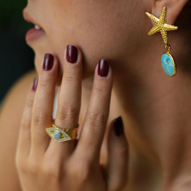 Turquoise Evil Eye Design Gold Adjustable Statement Ring, a bold and stylish piece designed to safeguard your energy while...