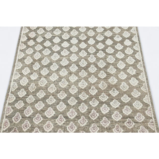 Hand-knotted in a luxurious blend of wool and silk, this 3x8 runner rug is a radiant and sophisticated addition to the Rug...