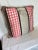 This beautiful tan pillow has a red houndstooth pattern with brown stripes.