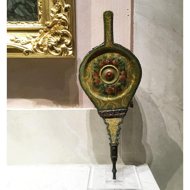 This is a rare fireplace bellows in carved and lacquered wood with polychrome decorations of flowers on a light green...