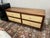 This is a barely used, custom made, mid century modern grasscloth cane front dresser featuring four spacious drawers with...