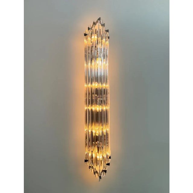 Italian wall light with clear hand blown crystals cut to three points in Triedri technique, mounted on back plate and...