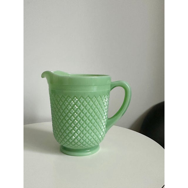 1930s Vintage Art Deco Jadeite Glass Pitcher This vintage pitcher is crafted from green glass, adding a touch of nostalgia...