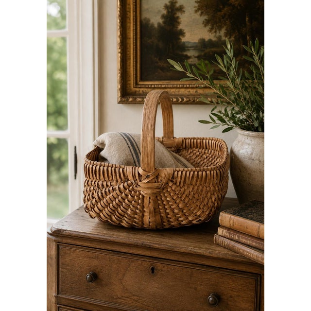 A beautifully woven early 20th century American splint oak basket with warm honeyed tones and a tightly constructed...
