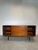 Bring timeless design into your home with this elegant mid-century modern sideboard. with its clean lines, warm wood...