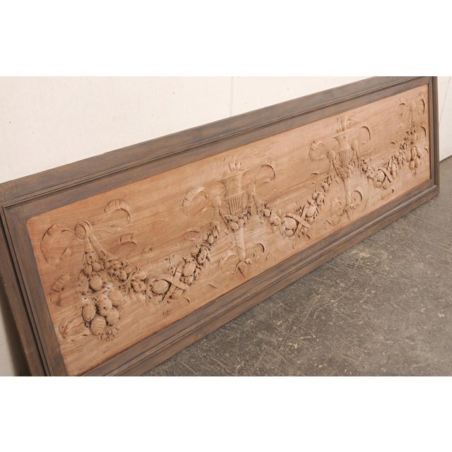 A French Neoclassical, large-sized, carved-wood wall panel from the 19th century. This antique wall decoration from France...