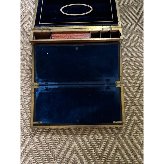 A lovely Edwardian era sailors writing desk, I believe that the wood is walnut. The interior has a lovely royal blue...