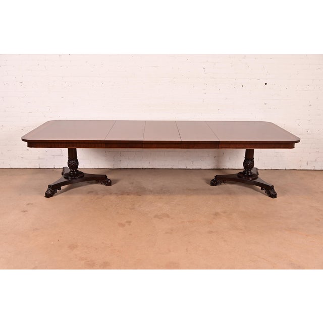An exceptional Regency or Neoclassical style double pedestal extension dining table By Baker Furniture USA, Circa 1980s...