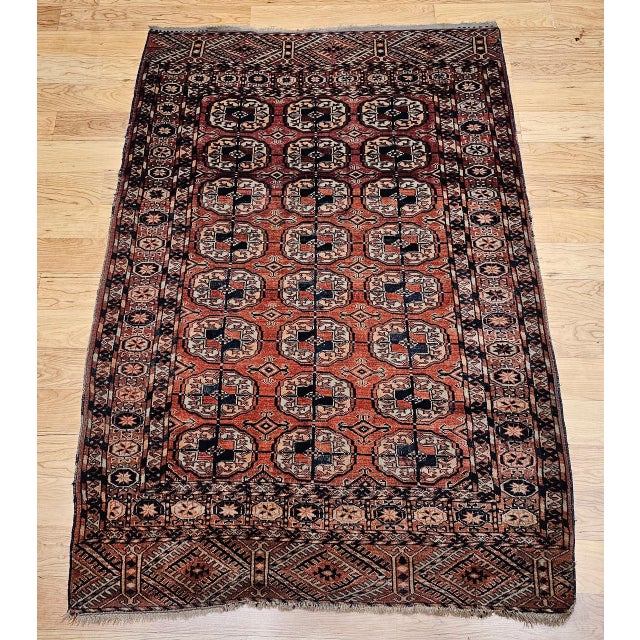 This beautifully preserved early 20th century Turkmen Tekke area rug features the classic allover small gul medallion...