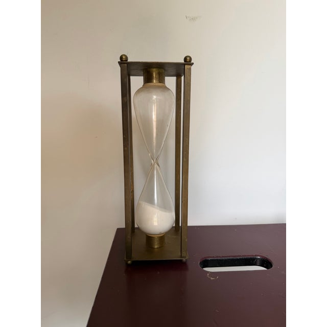 Mid-century vintage brass glass and sand hour glass. Measures 10 5/8 inches tall by 3.5" square