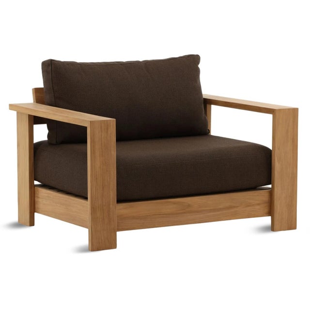Outdoor solid natural teak wood frame accent chair with rich chocolate brown cushions. Each chair may vary in exact...