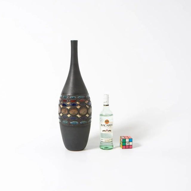 This colorful vase was created in the workshop of Perginem in the 1970s. This hand-thrown vase has a beautiful shape and a...