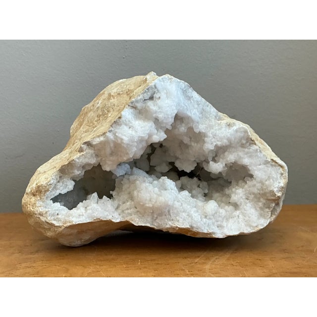 Formed through millennia of natural geological crystallization, this vintage white quartz geode specimen features a...
