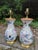 An elegant pair of vase-form ceramic table lamps attributed to Vaughan Designs, featuring pink and lavender roses with...