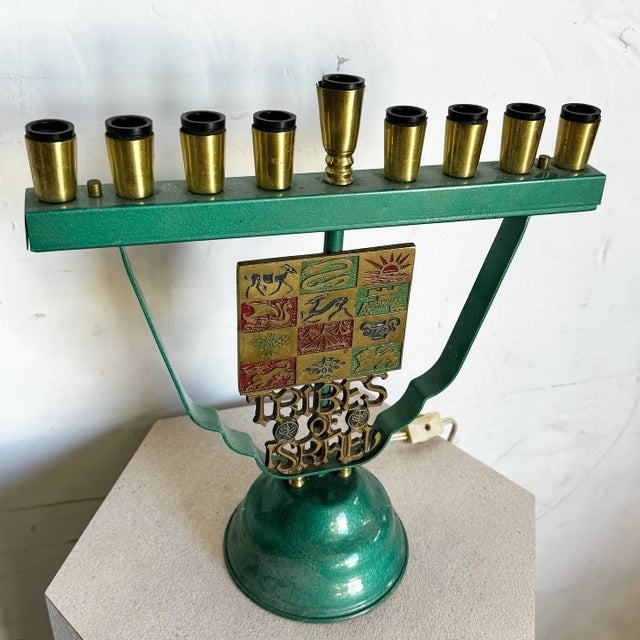 Celebrate tradition with this stunning vintage menorah lamp featuring the “12 Tribes of Israel” motif. The vibrant brass...