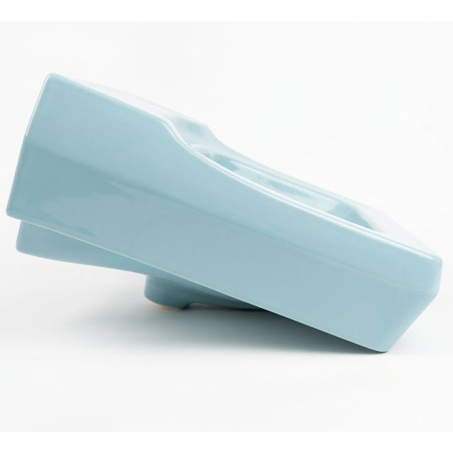 This striking porcelain bathroom basin is a contemporary tribute to the optimistic geometry of the 1950s. Finished in a...