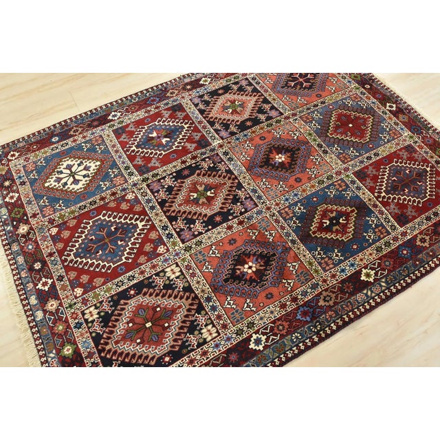 An authentic vintage tribal Yalameh rug hand-knotted with fine wool and natural dyes. This finely woven nomadic rug...