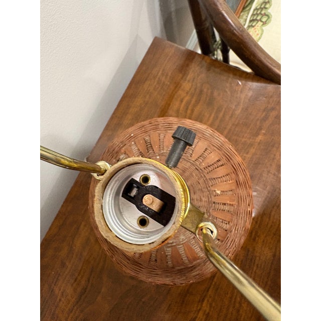 Smaller fine wicker urn-shaped basket lamp. Mid-century. Nice rustic cabin look. Recently rewired. Original finial and...