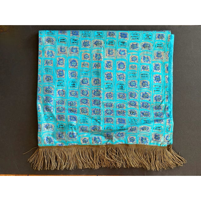 Made from block printed silk fabric, this vintage table runner has gold bullion tassels on each end. The vintage silk...