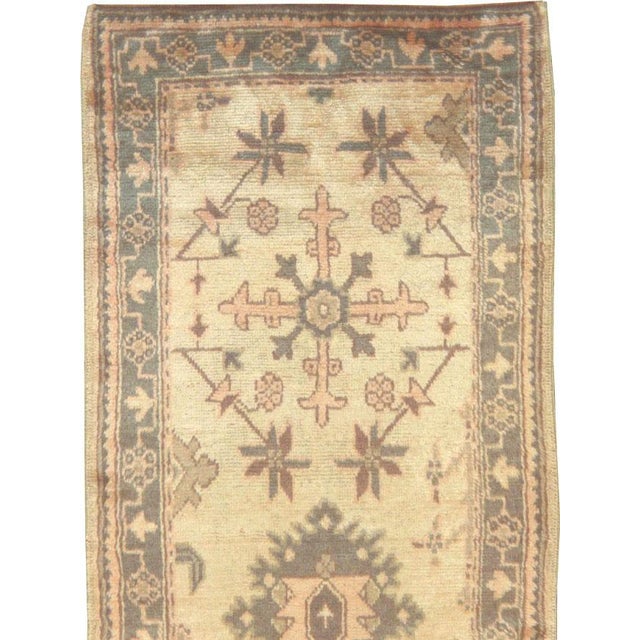 A vintage Turkish Oushak rug in runner format handmade during the mid-20th century. Until the Great Persian Carpet Revival...