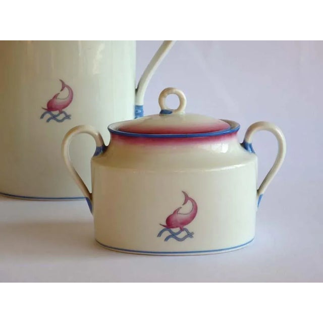 This porcelain set with decoration in pink and blue was designed by Gio Ponti. The set features a milk jug and sugar bowl...