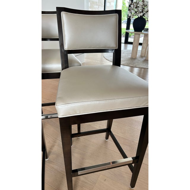 Custom bar-height stools from Century Furniture. Produced in 2024, these five (5) bar stools are made of solid oak frames...